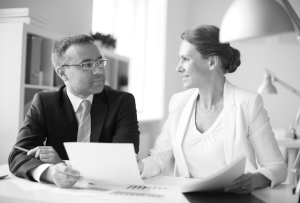 a man with glasses is facing a smiling woman